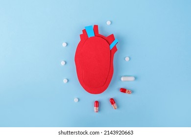 Anatomical Heart - Human Organ From Paper On Blue Background. World Heart Day. Medicines And Pills For Treatment Of Illness. 