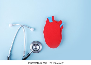 Anatomical Heart - Human Organ From Paper And Stethoscope On Blue Background. World Heart Day. Diagnosis, Prevention And Treatment Of Heart Disease