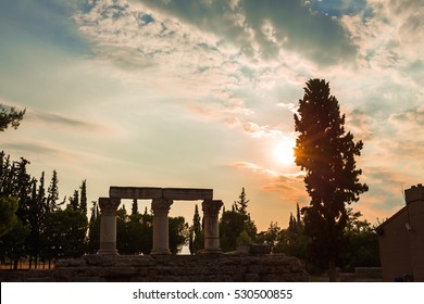 Anchient ruins of temple in Corinth, The lights of sun brights through tree. Greece - archaeology background