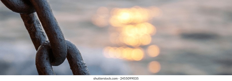 Anchor chain and sea. Chain close-up on the background of the sea at sunset. Sea waves in the evening out of focus. - Powered by Shutterstock