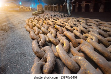 Anchor Chains Bundle Laying At Bottom Layer Of The Ship In Floating Dry Dock, For Recondition Maintenance With Sand Blasting Perform, Worker Paint Man Spraying Condition In Background