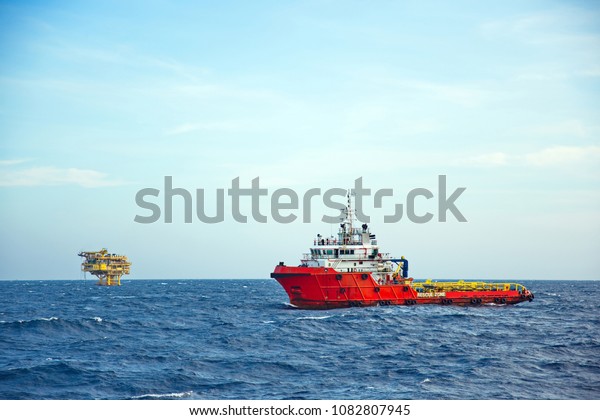 Anchor Handling Tug Supply (AHTS) Ship\
while operation and standby near petroleum\
platform