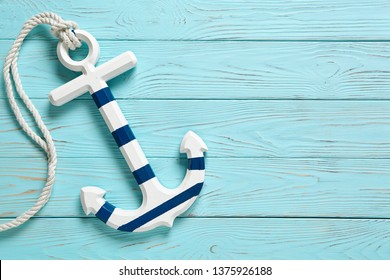 Anchor on a blue vintage wooden background.