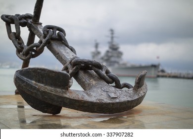 Anchor on the embankment and the cruiser "Mikhail Kutuzov"  in the port of Novorossiysk, Russia