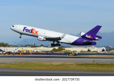 Anchorage, AK, USA - September 12 2018: FedEx Cargo Aircraft McDonnell Douglas MD-11F Taking Off From Anchorage Airport. Federal Express Freighter Airplane MD11. Plane Departing.