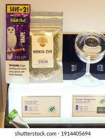 Anchorage, Alaska, United States – August 1, 2019: Part Of The Interior Of Great Northern Cannabis, A Cannabis Dispensary In Downtown Anchorage; Display Case Of Cannabis Products And Cigars.