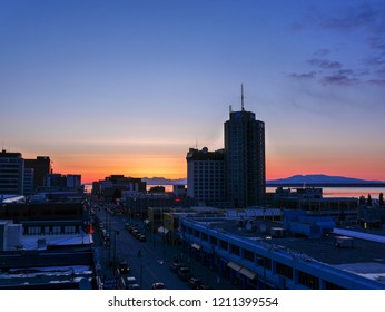 Anchorage, Alaska / USA - March 30 2018: Downtown Anchorage silhouetted by the setting sun