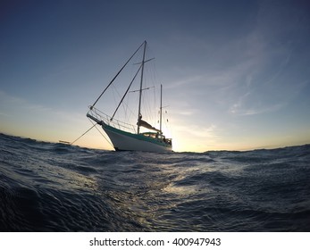 Anchored Down Sailing Boat With The Sunset In The Back. Cairns, Queensland, Australia.