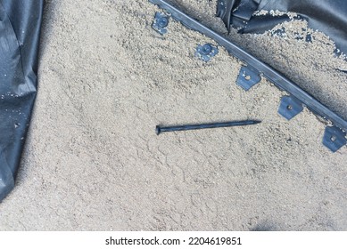 Anchoring Spikes Next To Black Plastic Landscape Edging With Level Paver Sand And Weed Barrier At Sidewalk Project Construction. Homeowner Walkway Under Installation In Texas, USA