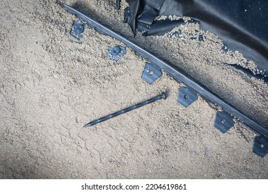 Anchoring Spikes Next To Black Plastic Landscape Edging With Level Paver Sand And Weed Barrier At Sidewalk Project Construction. Homeowner Walkway Under Installation In Texas, USA