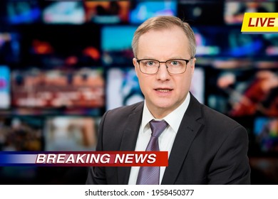 An Anchorman Reporting Live Breaking News Sitting In Tv Studio. Background Of Multiple Screens Of Broadcast Control Room. Journalism Concept