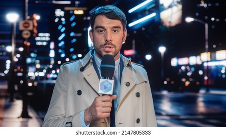 Anchorman Reporting Live News In A City At Night. News Coverage By Professional Handsome Reporter From A Business District. Journalist Presenting News For TV Channel. Newscaster Talking. Static Shot.