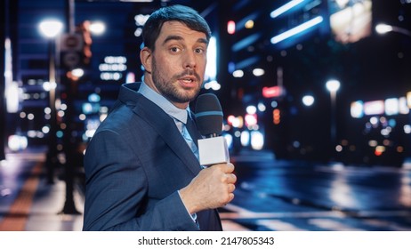 Anchorman Reporting Live News In A City At Night. News Coverage By Professional Handsome Reporter From A Business District. Journalist Presenting News For TV Channel. Newscaster Talking.