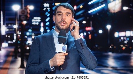 Anchorman Reporting Live News In A City At Night. News Coverage By Professional Handsome Reporter From A Business District. Journalist Presenting News For TV Channel. Newscaster Talking.