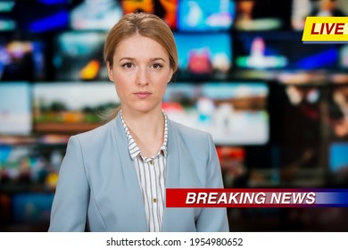 An Anchorwoman Reporting Live Breaking News Sitting In Tv Studio. Background Of Multiple Screens Of Broadcast Control Room. Journalism Concept