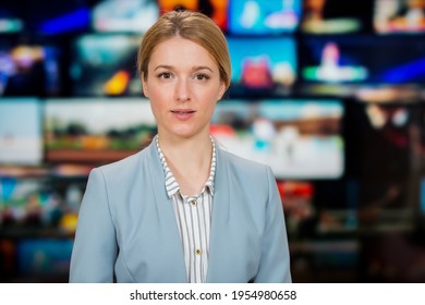 An Anchorwoman Reporting Live Breaking News Sitting In Tv Studio. Background Of Multiple Screens Of Broadcast Control Room. Journalism Concept