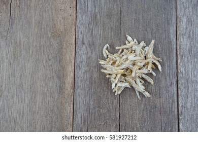 Anchovy (ikan bilis), isolated on wooden table background