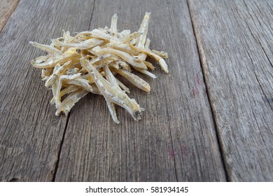 Anchovy (ikan bilis), isolated on wooden table background