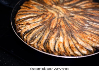 Anchovy In A Round Teflon Pan On The Stove