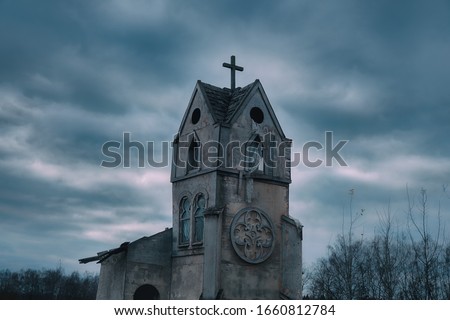 Ancient abandoned Church against a dark sky. Cityscape on Halloween, copy space