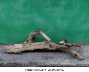 Ancient aesthetic abstract contemporary sculpture using wood material on a green background - Powered by Shutterstock