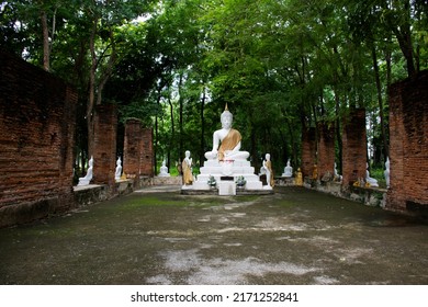 Ancient antique white buddha statue in antique ruin ubosot for thai people traveler travel visit and respect praying blessing holy mystery of Wat Phra Kaew temple at Chainat city in Chai Nat, Thailand