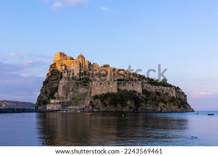 Ancient Aragon Castle on the Island Of Ischia (Castello Aragonese d'Ischia) on a cliff in the Mediterrenian Sea in Italy against a blue sky seen at golden hour