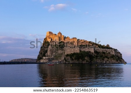 Ancient Aragon Castle on the Island Of Ischia (Castello Aragonese d'Ischia) on a cliff in the Mediterrenian Sea in Italy against a blue sky seen at golden hour