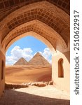 Ancient arch at entrance to Great Pyramids in Giza pyramid complex (Giza Necropolis), Egypt. View of sand dunes and pyramids of Chephren and Cheops through stone arch. Travel, resort, vacation concept