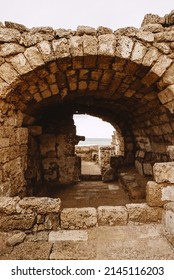 An ancient arch made of stone bricks. Caesarea. Israel