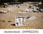 Ancient artistic fresco with three statues from ancient Greece at the excavation site of a Temple of Zeus 