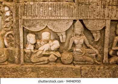 Ancient Bas Relief Carving Showing A Woman Receiving Khmer Massage.  Wall Of Bayon Temple, Angkor Thom, Siem Reap, Cambodia.