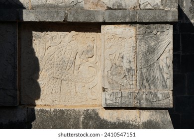 Ancient bas-relief carvings of Mayan eagle and jaguar warriors on stone slabs in sunlight - Powered by Shutterstock