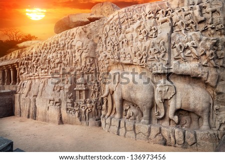 Ancient basrelief of Elephants and another hindu deities at sunset sky in Mamallapuram, Tamil Nadu, India