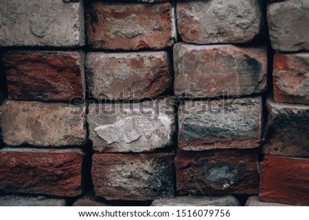 Ancient bricks. Old brickwork. Vintage red brick wall closeup. Photo background with ends of bricks