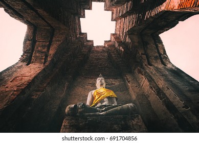 The ancient Buddha is enshrined in an ancient temple in Ayutthaya, Thailand.