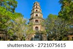 Ancient Buddhist Stupa and Stone Pillars in the Pine Forest Garden of Thien Mu Pagoda, Hue, Vietnam