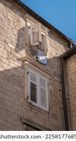 Ancient building facade and hanging laundry in a window, in Old Town Kotor, Montenegro - Shutterstock ID 2258177685