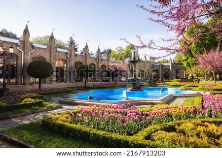 Ancient building of the Narzan Gallery architectural monument of the 19th century with flower beds and a fountain, Kislovodsk, Russia