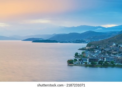 Ancient buildings and lake scenery in the ancient town of Dali City, Yunnan Province, China under the beautiful sunset
