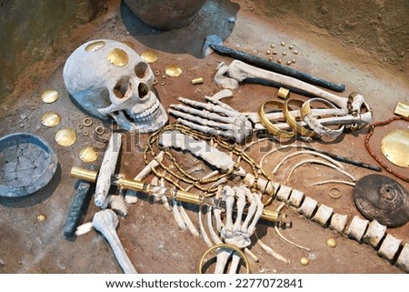Ancient burial skeleton with golden decorations in the museum