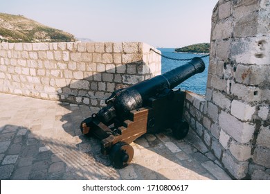 An ancient cannon with kernels on the wall of the old city of Dubrovnik