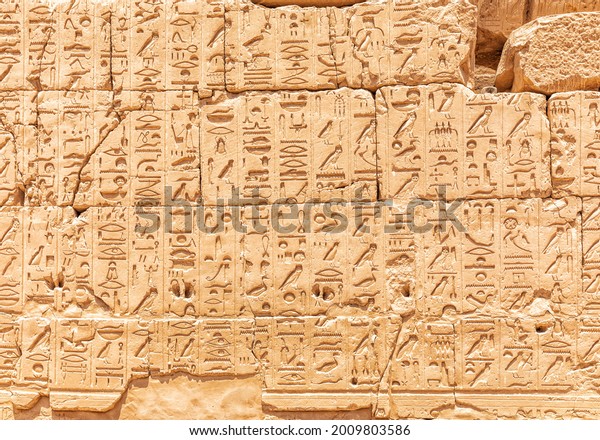 Ancient carvings on the wall of the Karnak Temple,\
Luxor, Egypt