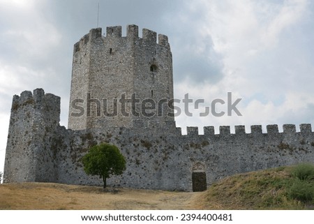Ancient Castle Amongst Ruins with Fortified Walls and Sky. Elderly wall of ancient castle with historic ruins and fortification
