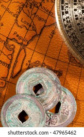 Ancient Chinese Coins And Compass (Luo Pan) Over Antique Map