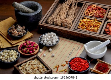 Ancient Chinese medicine books and herbs on the table.English Translation:Health preservation, Huangqi Danggui Decoction