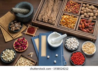 Ancient Chinese medicine books and herbs on the table - Shutterstock ID 1938524212