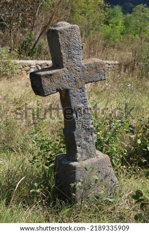 An ancient Christian grave cross in an old abandoned cemetery. Place of grief and sorrow. R.I.P.