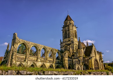 The Ancient Saint-Étienne-le-Vieux Church In The Center Of The Caen In Lower Normandy In Calvados, France. The Old Gothic Architecture In A Typically Norman Style Is Welcoming Travelers To Normandy