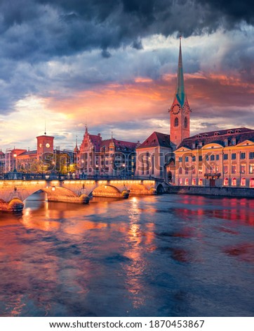Сharm of the ancient cities of Europe. Dramatic evening view of Fraumunster Church. Gorgeous summer cityscape of Zurich, Switzerland. Sunset on Limmat River. Architectural background.